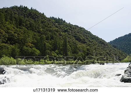 Stock Photo - Whitewater raft approaching waterfall. Fotosearch