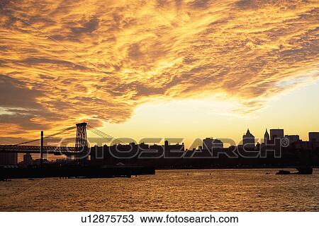 Stock Image - Williamsburg Bridge and sunset, New York City. Fotosearch