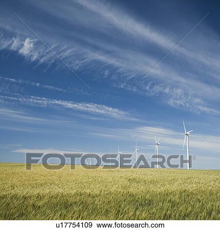 Stock Photo - Windmills in a row on wind farm. Fotosearch