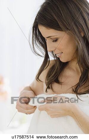 Woman adjusting towel View Large Photo Image Picture - Woman adjusting towel. Fotosearch
