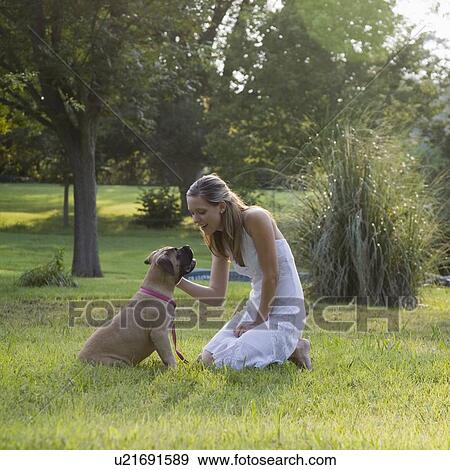 Stock Photo - Woman and dog in park. Fotosearch
