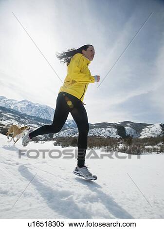 Woman and dog running in snow View Large Photo Image Stock Photography - Woman and dog running in snow. Fotosearch