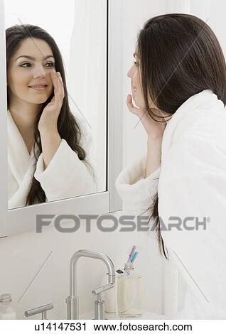 Woman applying face cream View Large Photo Image Stock Image - Woman applying face cream. Fotosearch