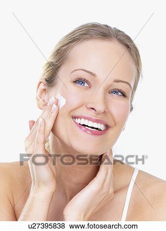 Woman applying face cream View Large Photo Image Stock Photo - Woman applying face cream. Fotosearch