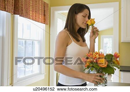 Woman arranging flowers at home View Large Photo Image Stock Image - Woman arranging flowers at home. Fotosearch
