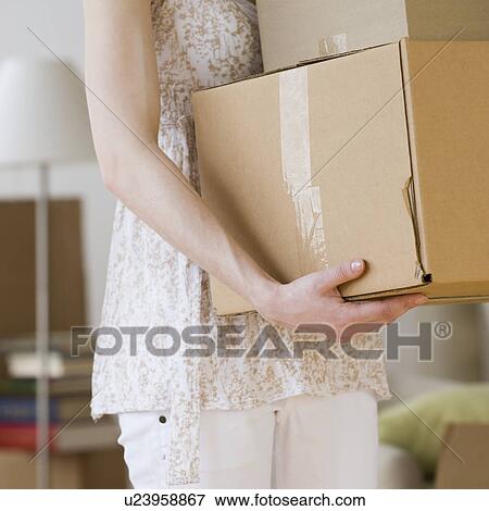 Woman carrying stack of moving boxes View Large Photo Image Stock Photo - Woman carrying stack of moving boxes. Fotosearch