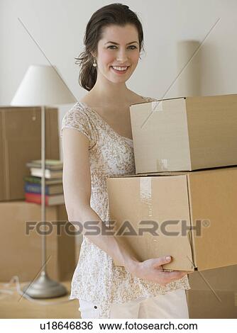 Woman carrying stack of moving boxes View Large Photo Image Stock Photograph - Woman carrying stack of moving boxes. Fotosearch