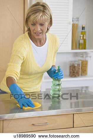 Woman cleaning kitchen counter View Large Photo Image Stock Image - Woman cleaning kitchen counter. Fotosearch