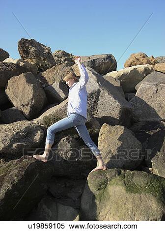 Woman climbing on rocks View Large Photo Image Stock Photography - Woman climbing on rocks. Fotosearch