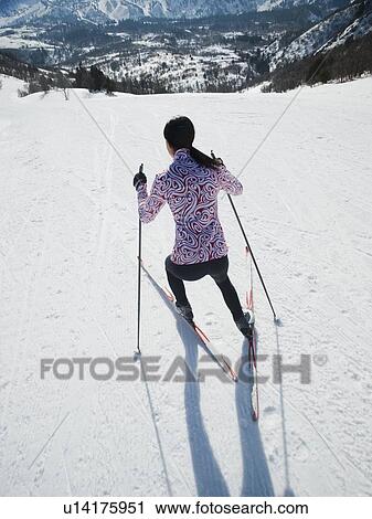 Stock Image - Woman cross country skiing. Fotosearch