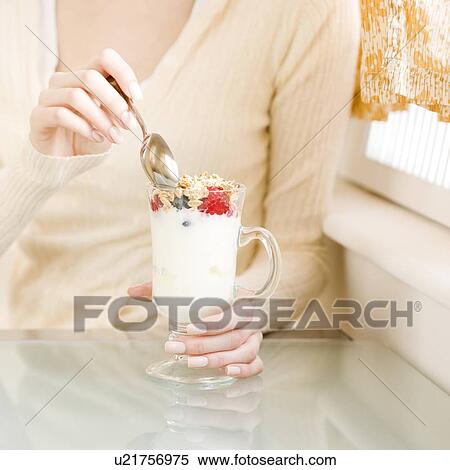 Woman eating breakfast parfait View Large Photo Image Stock Photography - Woman eating breakfast parfait. Fotosearch