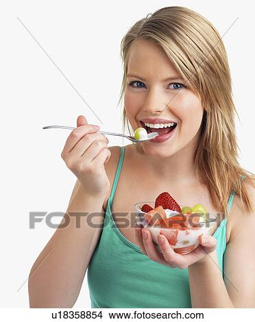 Picture - Woman eating fruit salad. Fotosearch
