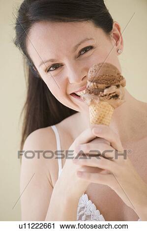 Woman eating ice cream cone View Large Photo Image Stock Image - Woman eating ice cream cone. Fotosearch