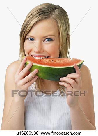 Stock Photograph - Woman eating watermelon. Fotosearch