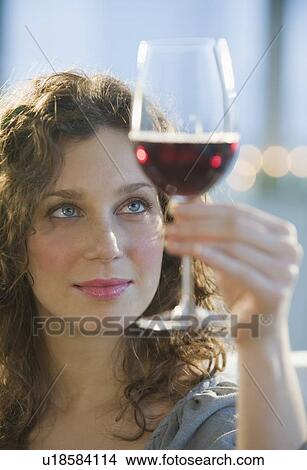 Woman examining coloring of red wine View Large Photo Image Picture - Woman examining coloring of red wine. Fotosearch
