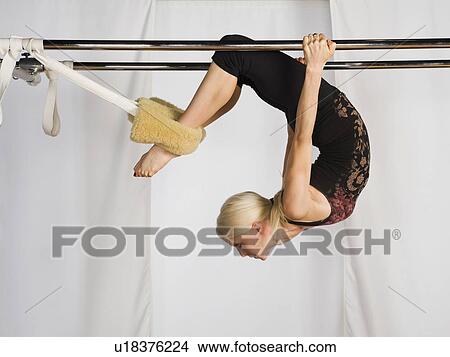 Woman exercising on pilates equipment View Large Photo Image Picture - Woman exercising on pilates equipment. Fotosearch