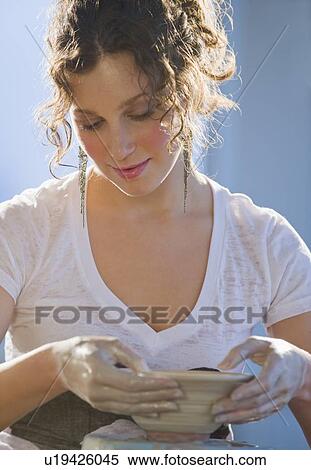 Woman forming bowl on pottery wheel View Large Photo Image Stock Photography - Woman forming bowl on pottery wheel. Fotosearch