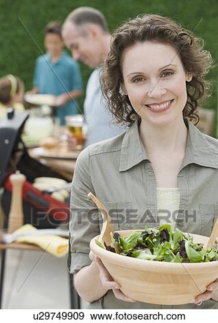 Stock Photo - Woman holding bowl of salad. Fotosearch