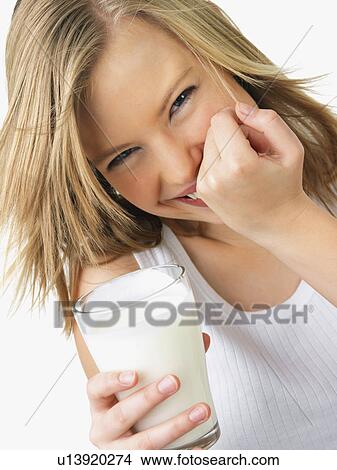 Picture - Woman holding glass of milk. Fotosearch