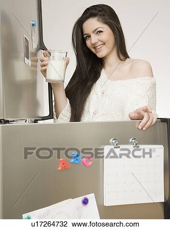 Woman holding glass of milk View Large Photo Image Stock Image - Woman holding glass of milk. Fotosearch