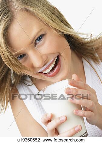 Woman holding glass of milk View Large Photo Image Stock Image - Woman holding glass of milk. Fotosearch
