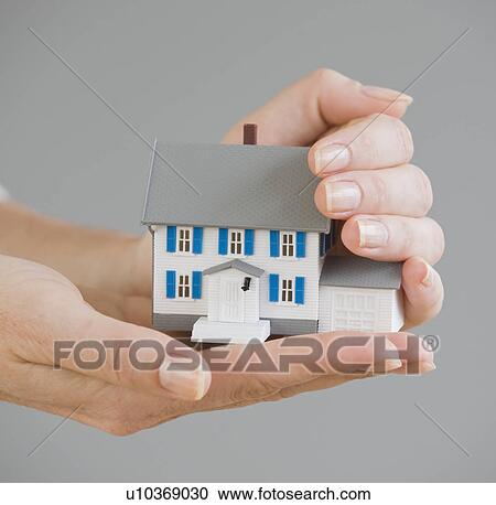 Woman holding model house View Large Photo Image Stock Image - Woman holding model house. Fotosearch