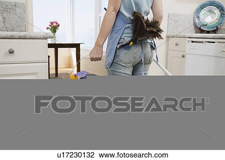 Woman holding mop and cleaning supplies View Large Photo Image Stock Image - Woman holding mop and cleaning supplies. Fotosearch