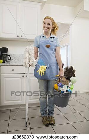 Woman holding mop and cleaning supplies View Large Photo Image Stock Image - Woman holding mop and cleaning supplies. Fotosearch