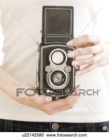 Stock Image - Woman holding old fashioned camera. Fotosearch