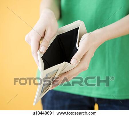 Woman holding open empty wallet View Large Photo Image Stock Image - Woman holding open empty wallet. Fotosearch