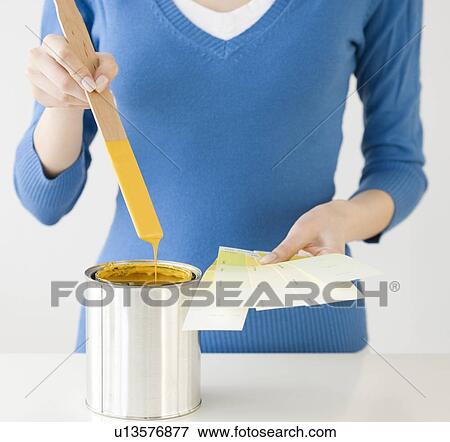 Woman holding paint swatches next to paint can View Large Photo Image Stock Photo - Woman holding paint swatches next to paint can. Fotosearch