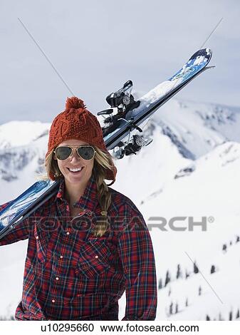 Woman holding skis on shoulder View Large Photo Image Stock Image - Woman holding skis on shoulder. Fotosearch