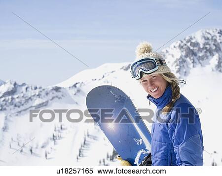 Stock Photography - Woman holding snowboard. Fotosearch
