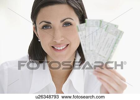 Stock Image - Woman holding tickets. Fotosearch