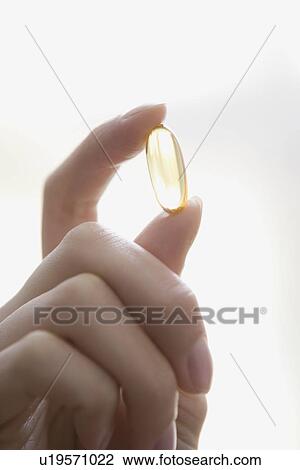 Woman holding vitamin View Large Photo Image Stock Image - Woman holding vitamin. Fotosearch