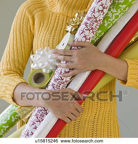 Woman holding wrapping paper View Large Photo Image Stock Photograph - Woman holding wrapping paper. Fotosearch