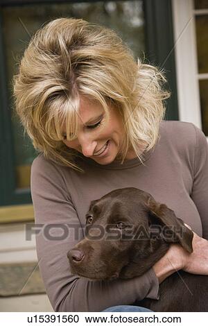 Woman hugging dog outdoors View Large Photo Image Stock Image - Woman hugging dog outdoors. Fotosearch