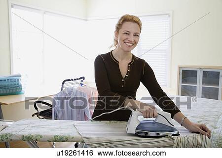 Stock Photograph - Woman ironing clothing. Fotosearch