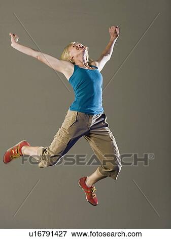 Stock Photo - Woman jumping in air. Fotosearch
