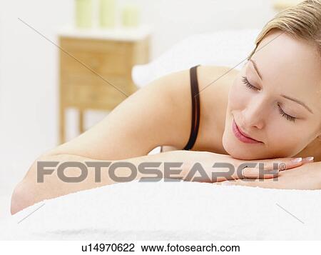 Stock Image - Woman laying on spa table. Fotosearch