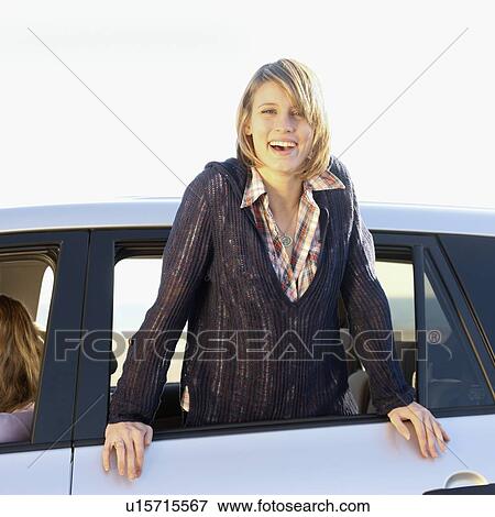 Woman leaning out of car window View Large Photo Image Stock Photo - Woman leaning out of car window. Fotosearch