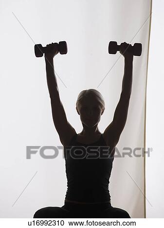 Stock Image - Woman lifting weights. Fotosearch