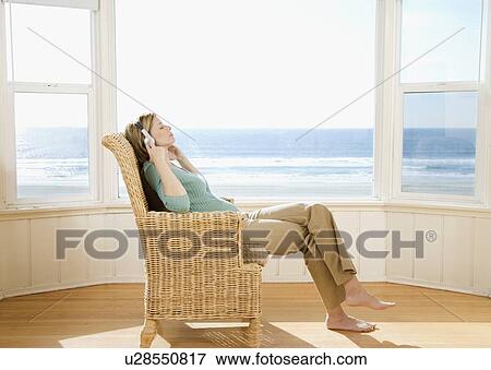 Woman listening to headphones View Large Photo Image Stock Photo - Woman listening to headphones. Fotosearch