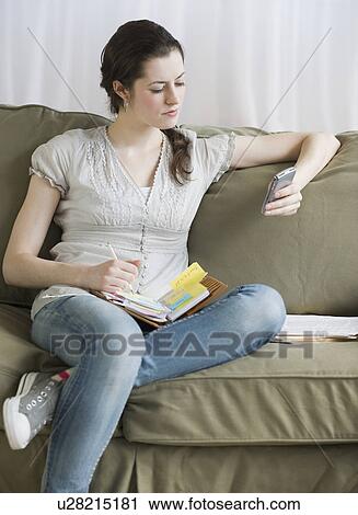 Woman looking at electronic organizer View Large Photo Image Stock Image - Woman looking at electronic organizer. Fotosearch