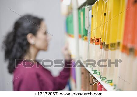 Woman looking at folders View Large Photo Image Stock Photo - Woman looking at folders. Fotosearch