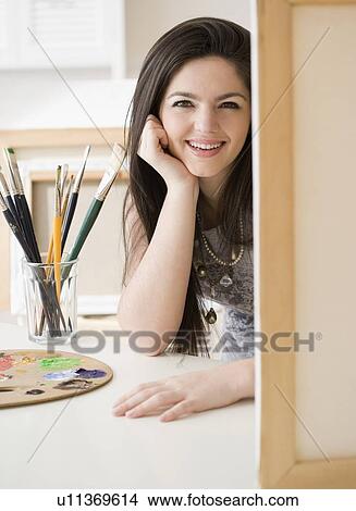 Woman next to paintbrushes and canvas View Large Photo Image Picture - Woman next to paintbrushes and canvas. Fotosearch