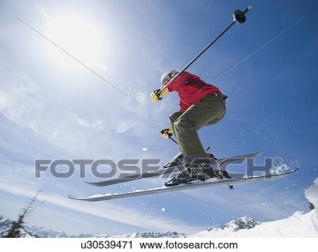 Woman on skis in air View Large Photo Image Stock Image - Woman on skis in air. Fotosearch