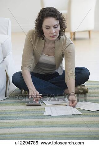 Woman paying bills on floor View Large Photo Image Stock Photography - Woman paying bills on floor. Fotosearch