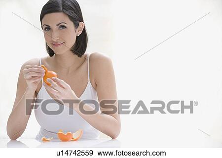 Woman peeling orange View Large Photo Image Stock Photo - Woman peeling orange. Fotosearch