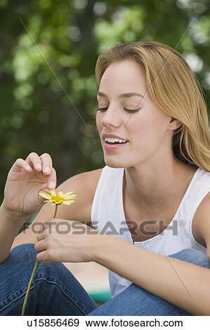 Woman picking petals off flower View Large Photo Image Stock Photo - Woman picking petals off flower. Fotosearch
